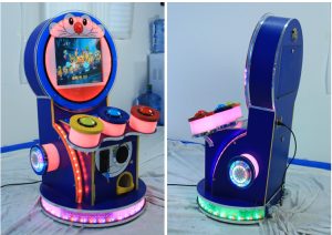 A colorful coin-operated Children's Mini Drummer designed for kids. The machine features vibrant graphics, a user-friendly interface, and interactive drumming gameplay. Ideal for arcades, family entertainment centers, and playrooms, it offers a fun and engaging musical experience for young players.