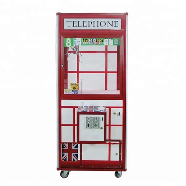 Phone booth style claw machine with colorful stuffed toys inside, attracting players with its vintage design