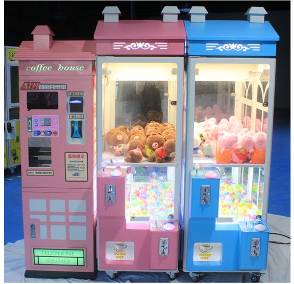 Phone booth style claw machine with colorful stuffed toys inside, attracting players with its vintage design