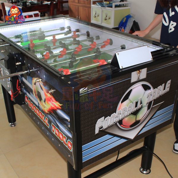 Coin-operated table football machine for kids and adults, perfect for arcades and entertainment venues.