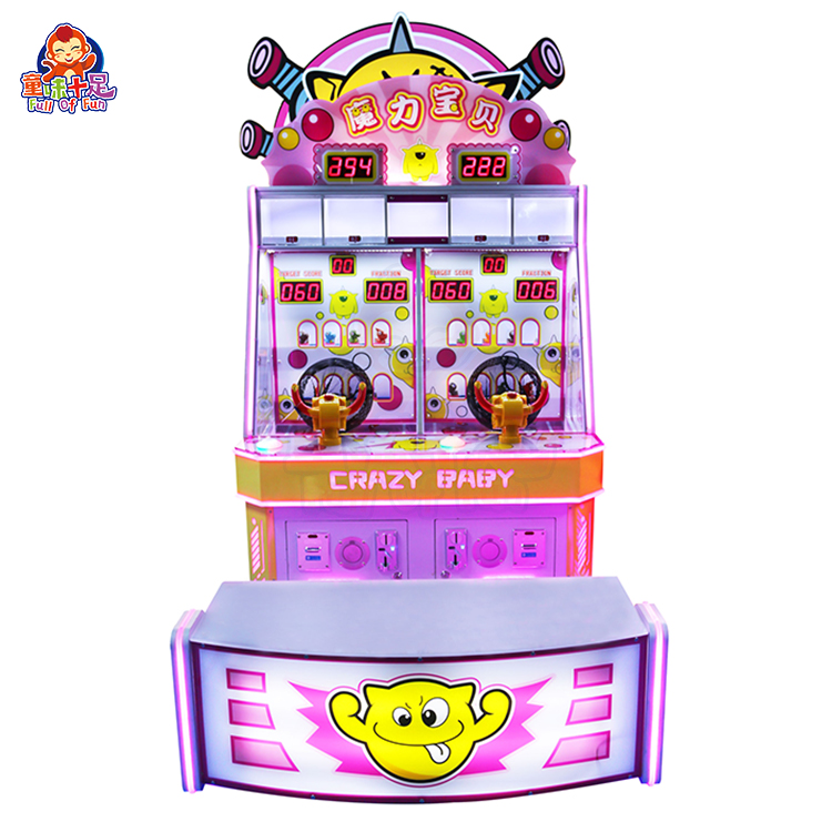 Child playing with the Magic Baby ball-shooting game machine in a colorful arcade.