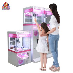 Mini claw machine with vibrant lights and small plush toys inside.