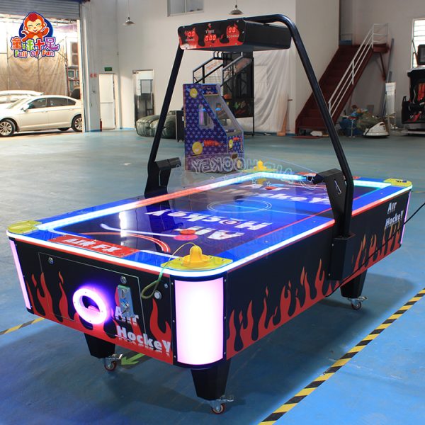 Coin-operated two-player flame air hockey table with LED lighting.