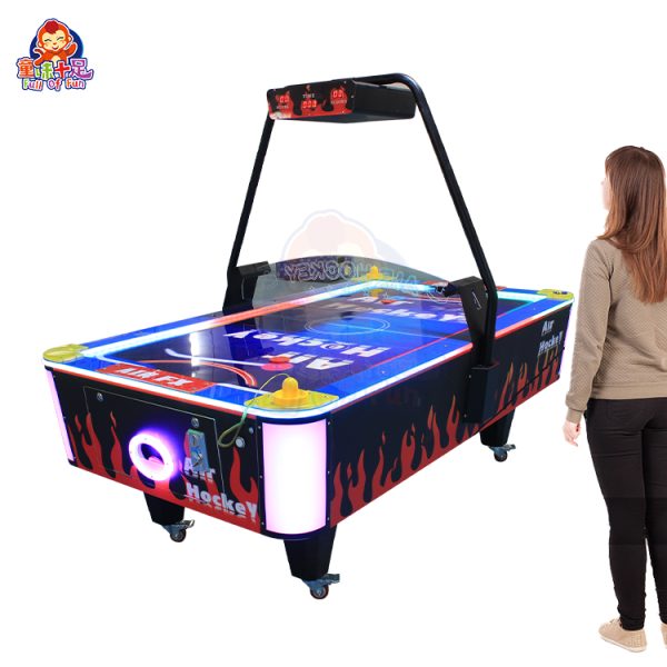 Coin-operated two-player flame air hockey table with LED lighting.