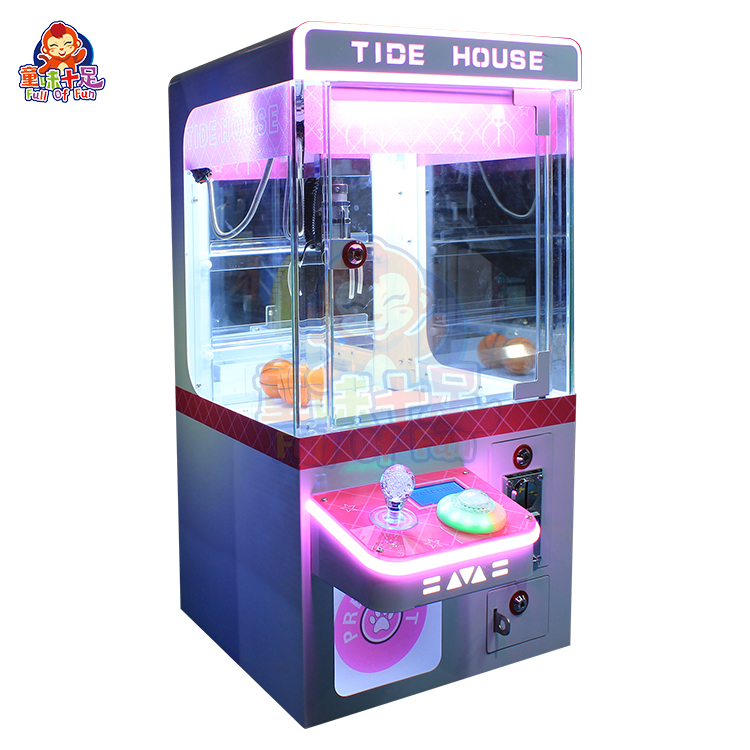 Compact coin-operated mini claw machine for children’s amusement.