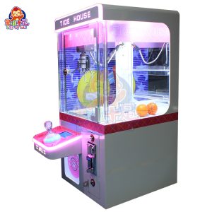 Compact coin-operated mini claw machine for children’s amusement.