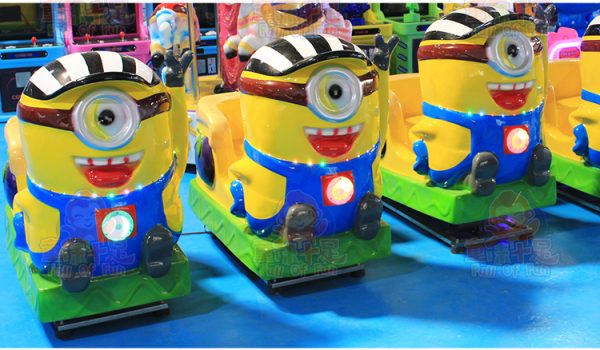 Minion-themed kiddie ride with bright colors, lights, and sounds, designed for young children’s entertainment.